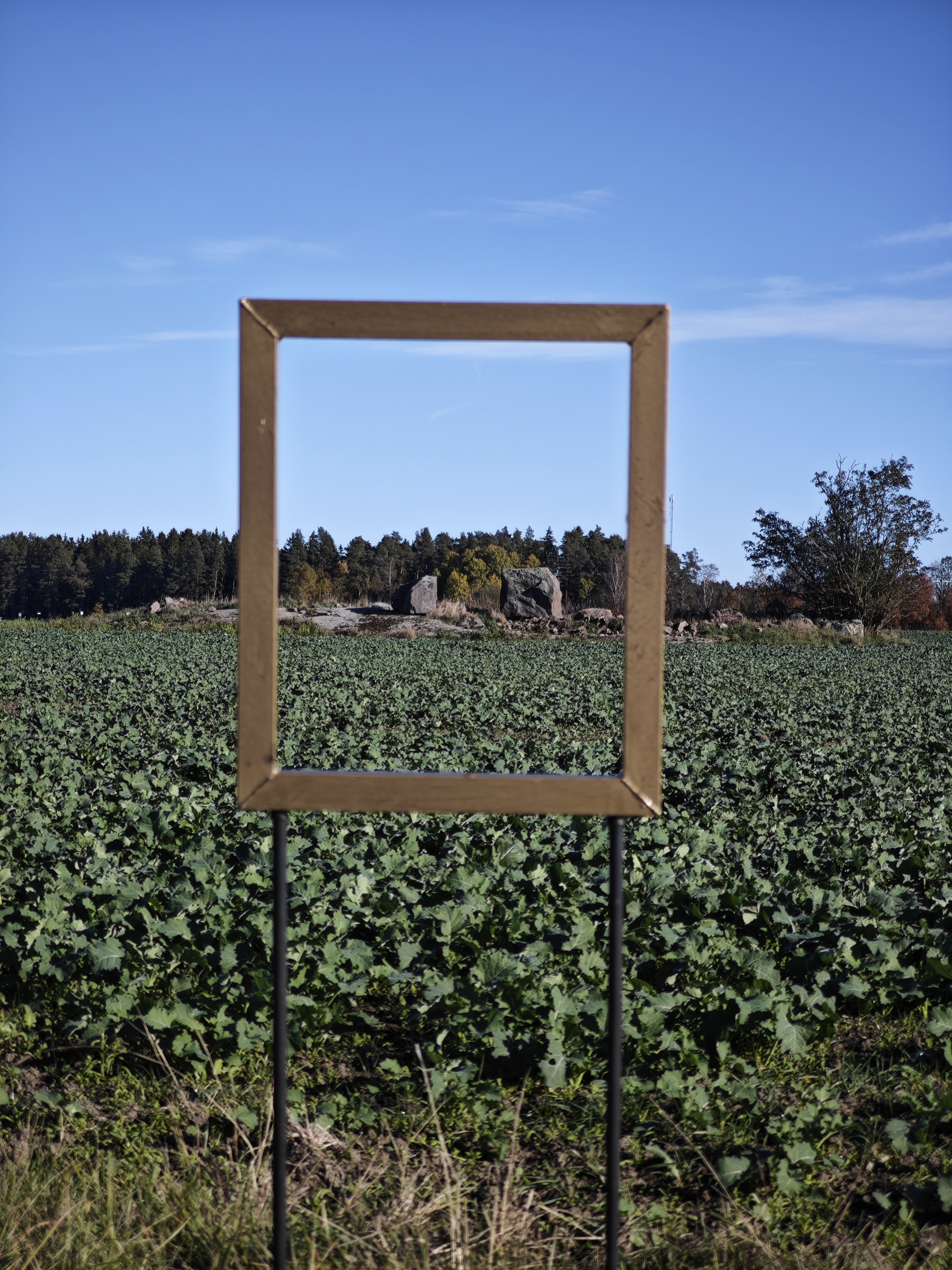 A nearby farm ruin framed through a viewing frame on event day